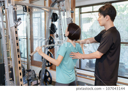 A woman training at a personal gym A woman training at a personal gym 107043144