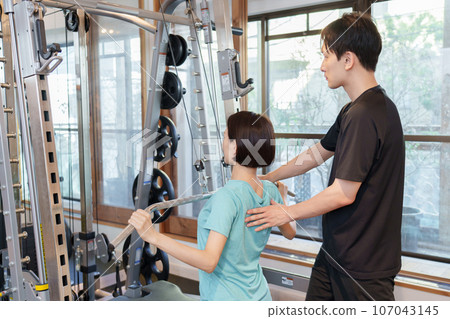 A woman training at a personal gym 107043145