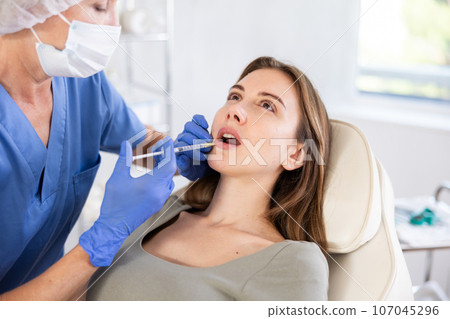 Facial injection young patient, closeup 107045296