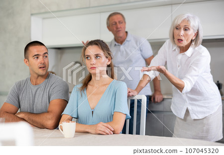 Old couple quarrel with young couple Old couple quarrel with young couple 107045320