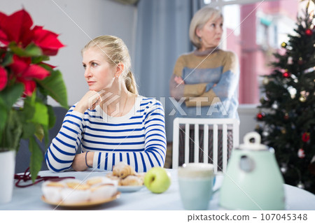 Portrait of an offended adult daughter at her elderly mother 107045348