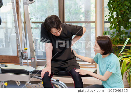 A man hurt his back at a personal gym A man hurt his back at a personal gym 107046225