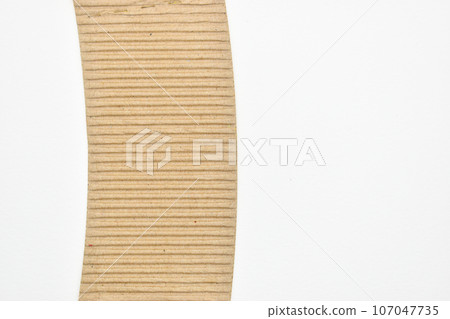 closeup brown paper cardboard texture on white background closeup brown paper cardboard texture on white background 107047735