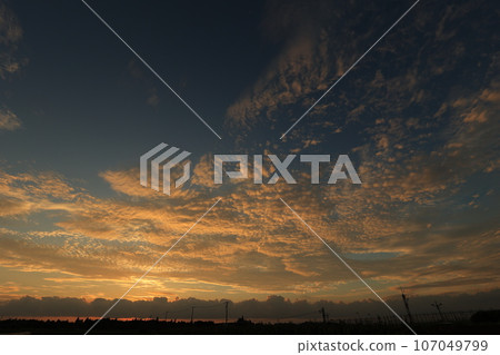 Clouds illuminated by the sunset Clouds illuminated by the sunset 107049799