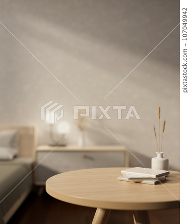 Copy space on a wooden round table in a cozy, minimalist bedroom. close-up image 107049942