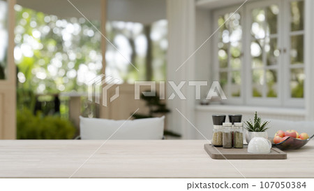 Copy space on a wooden dining table in a modern and comfortable dining room or living room. Copy space on a wooden dining table in a modern and comfortable dining room or living room. 107050384