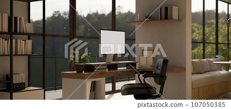 A computer mockup on a desk in a modern, contemporary spacious home office or private office room. A computer mockup on a desk in a modern, contemporary spacious home office or private office room. 107050385