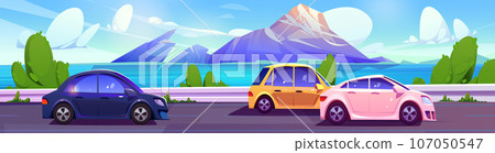 Cars driving on road along river or sea, mountains 107050547
