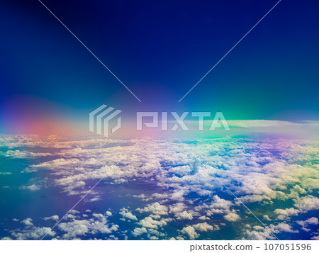 Blue sky, white clouds, and blue sea seen from an airplane 107051596