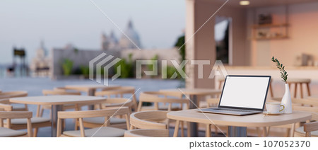 A white screen laptop mockup on a table in a modern and contemporary co-working space or coffee shop A white screen laptop mockup on a table in a modern and contemporary co-working space or coffee shop 107052370