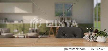 A copy space on a wooden desk with stationery in a modern home living room blurry background. 107052376
