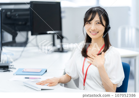 Young business woman working in a call center Young business woman working in a call center 107052386