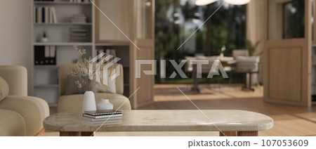 Copy space for displaying your product on a white marble coffee table in a modern cozy living room. 107053609