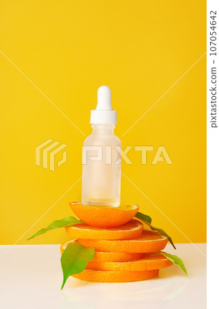 Skincare oil bottle on stacked orange slices Skincare oil bottle on stacked orange slices 107054642