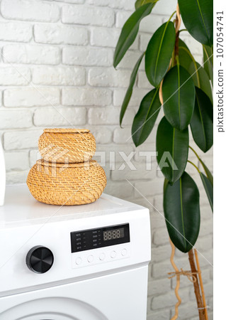 Modern white washing machine close up photo Modern white washing machine close up photo 107054741