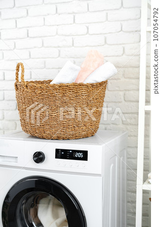 Laundry basket on washing machine in a laundry room 107054792