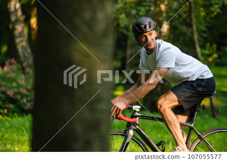 Cyclist on a bike on the road in the park 107055577