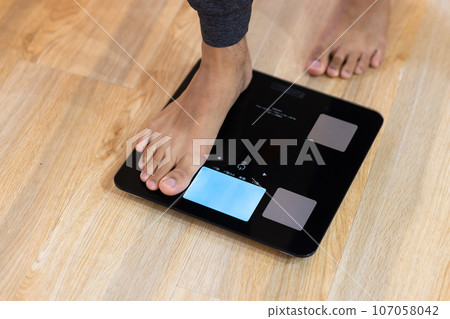 Men riding a scale Men riding a scale 107058042