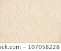 Crumpled natural paper, wrinkled beige paper texture 107058228