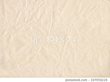 Crumpled natural paper, wrinkled beige paper texture 107058228