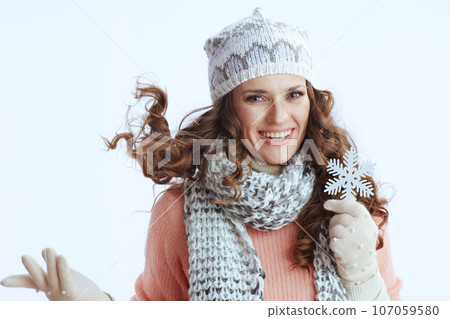 happy stylish woman in sweater, mittens, hat and scarf on happy stylish woman in sweater, mittens, hat and scarf on 107059580