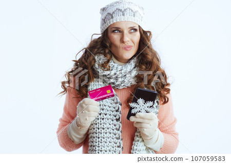 pensive trendy woman on white buying on internet pensive trendy woman on white buying on internet 107059583