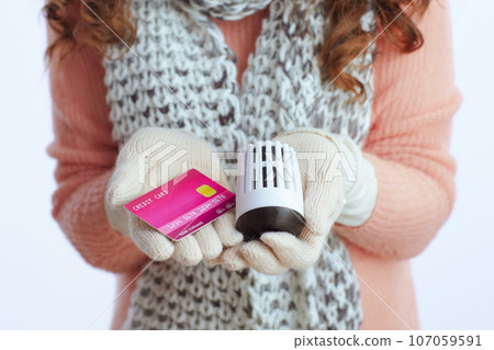 Closeup on modern woman in sweater, mittens, hat and scarf Closeup on modern woman in sweater, mittens, hat and scarf 107059591