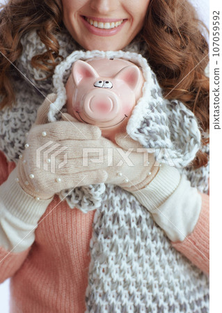 Closeup on trendy female in sweater, mittens, hat and scarf 107059592