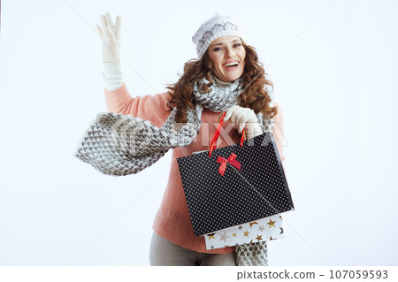 smiling stylish woman in sweater, mittens, hat and scarf on smiling stylish woman in sweater, mittens, hat and scarf on 107059593