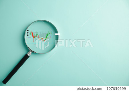 Bar graph with an upward arrow, indicating growth in the stock market, is analyzed through a magnifier glass. Business investment concept for earning income, analysis technical graph Bar graph with an upward arrow, indicating growth in the stock market, is analyzed through a magnifier glass. Business investment concept for earning income, analysis technical graph 107059699