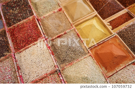 Condiments and spices in store trays closeup 107059732