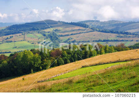 rural field on the steep hill. mountainous countryside scenery in early autumn. cloudy weather rural field on the steep hill. mountainous countryside scenery in early autumn. cloudy weather 107060215