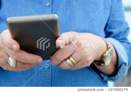 older woman using smart phone 107060274