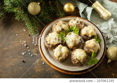 Traditional Polish Christmas dish on the table. Baked mushrooms stuffed with meat, bacon and cheese. Copy space. 107061195