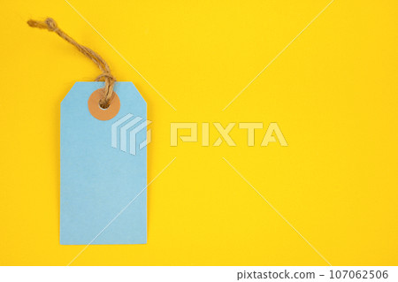 Blue color blank price tag on yellow background. Great for use as a price tag, gift tag, sale tag. 107062506
