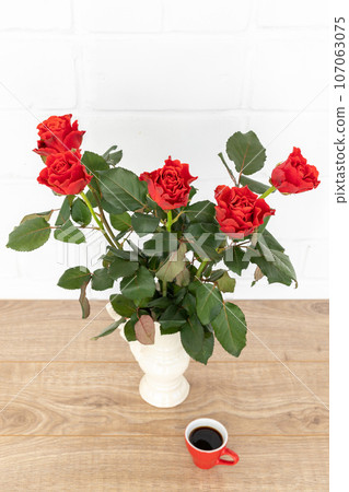 Beautiful bouquet of red roses in a ceramic vase. Beautiful bouquet of red roses in a ceramic vase. 107063075