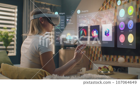 Woman in VR headset chooses clothes in online clothing store 107064649