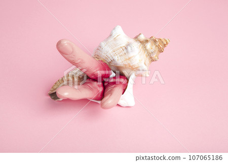 Fingers snatched from a corpse emerging from a conch shell Fingers snatched from a corpse emerging from a conch shell 107065186