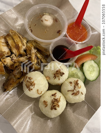 A plate of Roasted Chicken with riceball on the table A plate of Roasted Chicken with riceball on the table 107065558