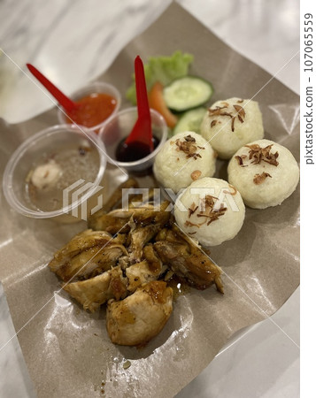 A plate of Roasted Chicken with riceball on the table A plate of Roasted Chicken with riceball on the table 107065559
