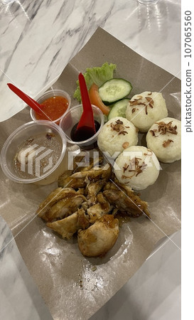 A plate of Roasted Chicken with riceball on the table A plate of Roasted Chicken with riceball on the table 107065560