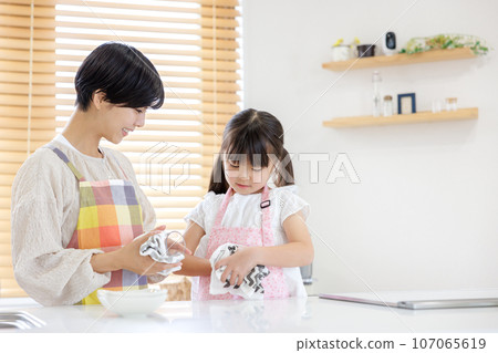 Mother and daughter help kitchen 107065619