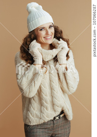 happy elegant woman against beige background happy elegant woman against beige background 107066287