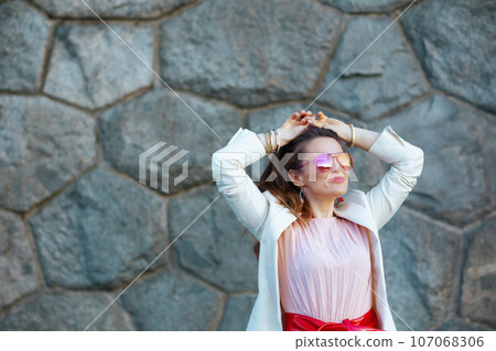 relaxed elegant 40 years old woman in dress and jacket in city relaxed elegant 40 years old woman in dress and jacket in city 107068306