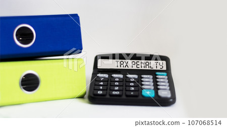 Word TAX PENALTY on calculator. Finance concept Word TAX PENALTY on calculator. Finance concept 107068514