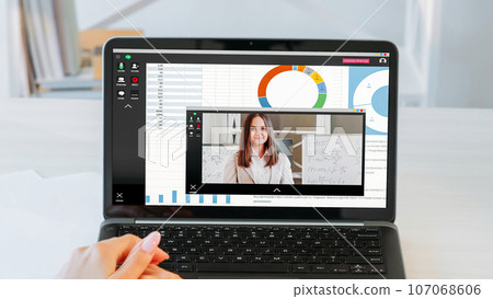 Internet studying. Video course. Woman hands at online lesson virtual class with female teacher presentation with whiteboard on laptop screen with charts graphs. Internet studying. Video course. Woman hands at online lesson virtual class with female teacher presentation with whiteboard on laptop screen with charts graphs. 107068606