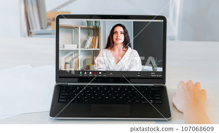 Video recruiting. Virtual chat. Confident successful woman applicant on laptop screen speaking to female business manager hand on desk at online interview at home office workplace. 107068609