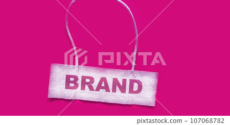 Brand, text on business card and pink background. Business handwriting concept brand essence - Brand, text on business card and pink background. Business handwriting concept brand essence - 107068782