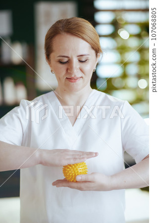 massage therapist woman in spa salon with massage ball 107068805