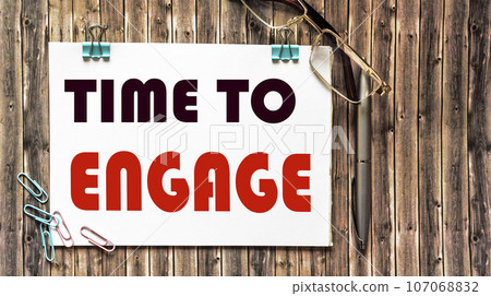 Phrase TIME TO ENGAGE wooden background, top 107068832